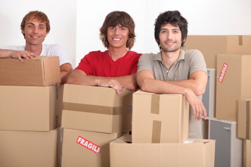 Local moving team loading furniture into a van in Brimsdown