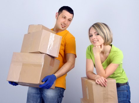 Packed moving boxes and home items ready for collection